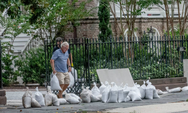 A man placing sandbags.
